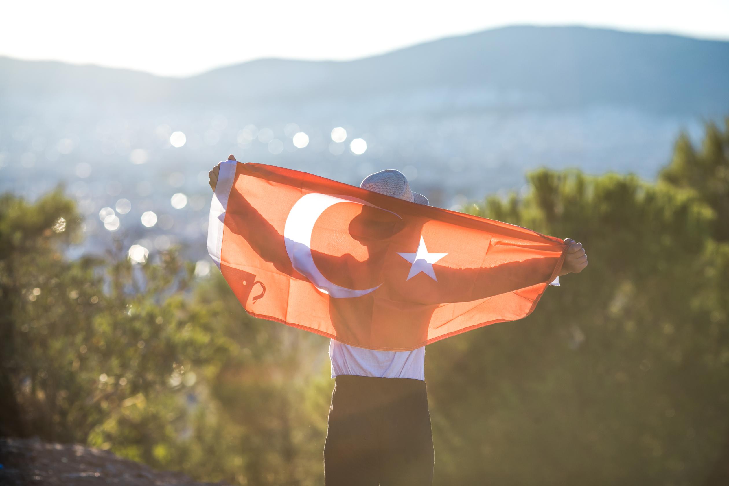 boy-holding-turkey-flag-against-city-kid-hand-wa-2023-11-27-05-16-08-utc (1).jpg