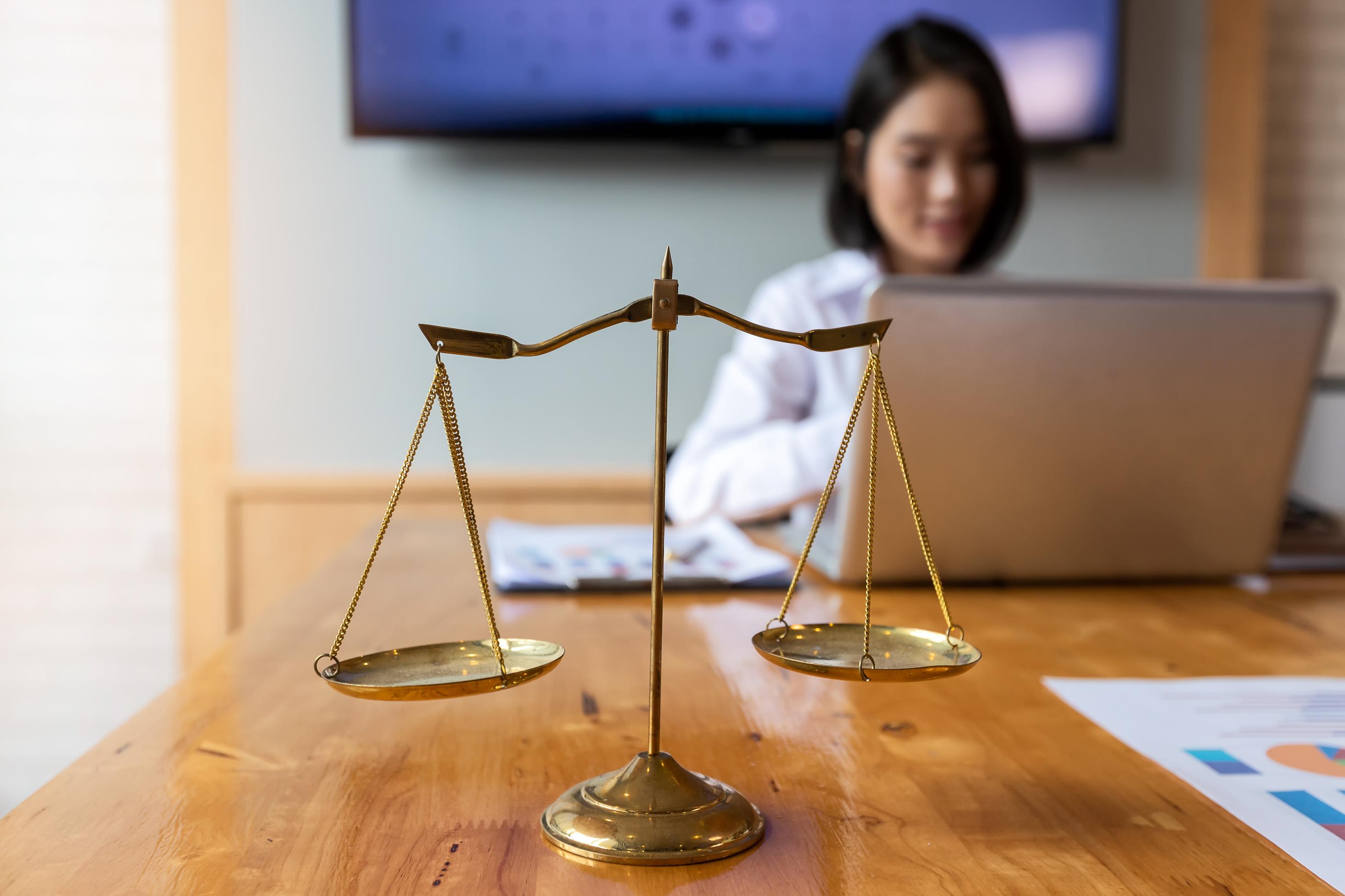 gold-brass-balance-scale-over-with-lawyer-backgrou-2023-11-27-05-34-02-utc (1).jpg